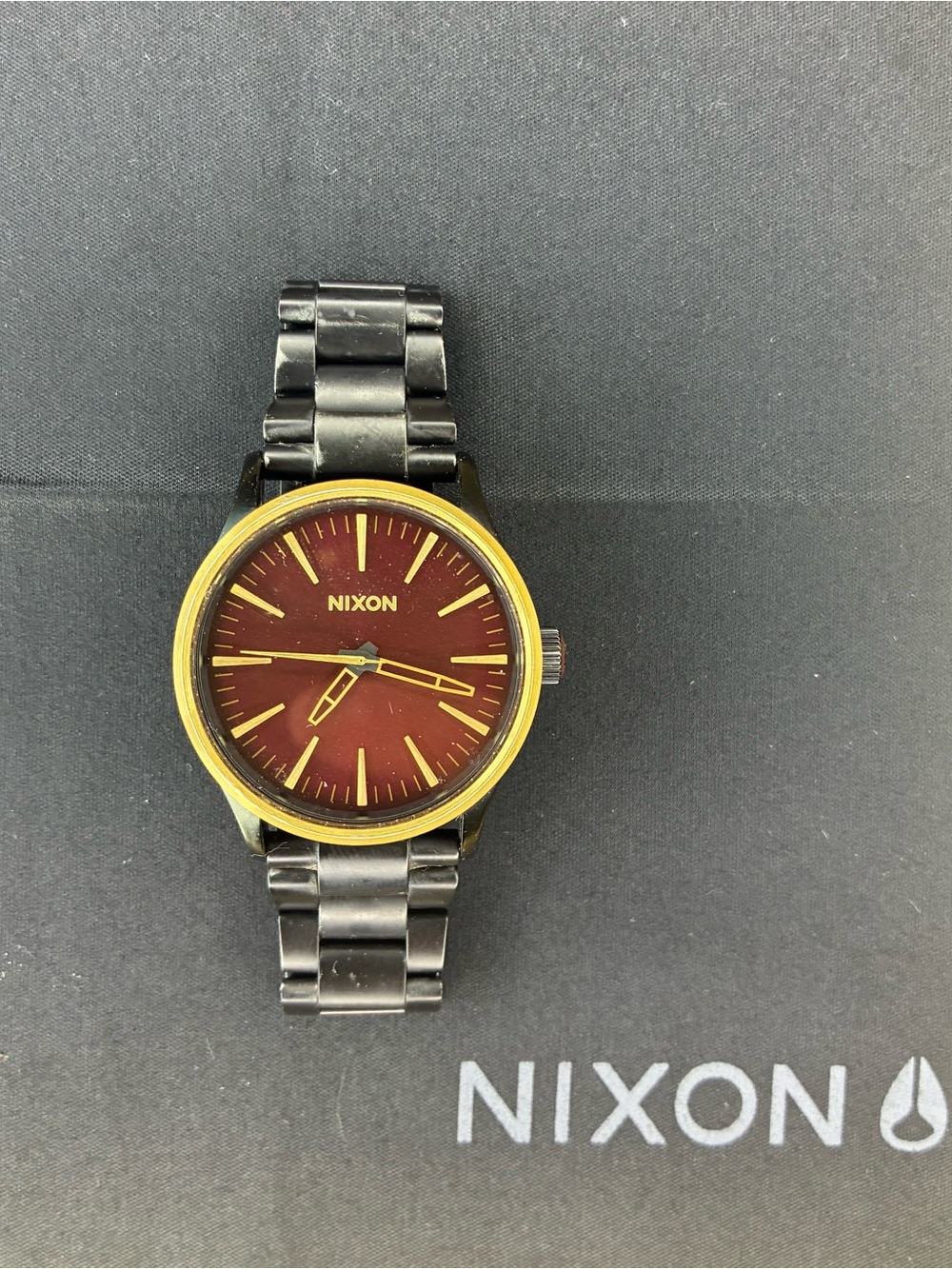 Nixon Sentry 38 SS Gold, Black, Red Stainless Steel Watch